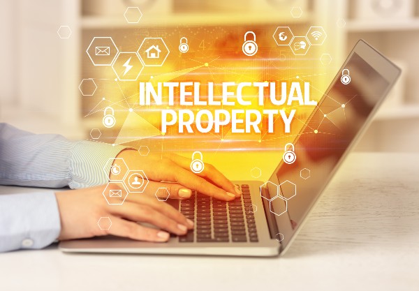 Yellow Intellectual Property Graphic in Front Laptop